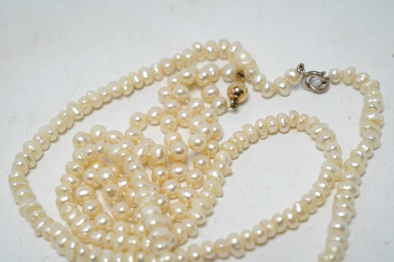 A single strand cultured pearl choker necklace, with 375 clasp, 38cm, together with a freshwater pearl necklace with 925 clasp. Condition - fair